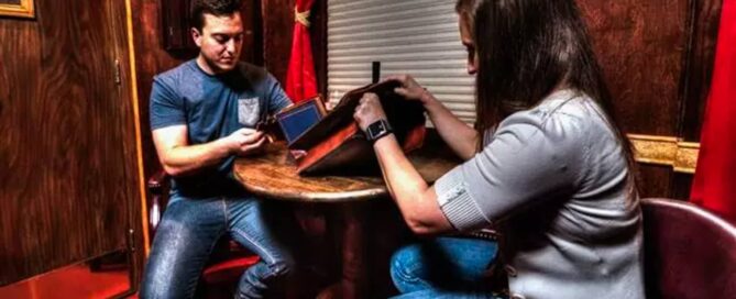 A couple searching for clues in an escape game