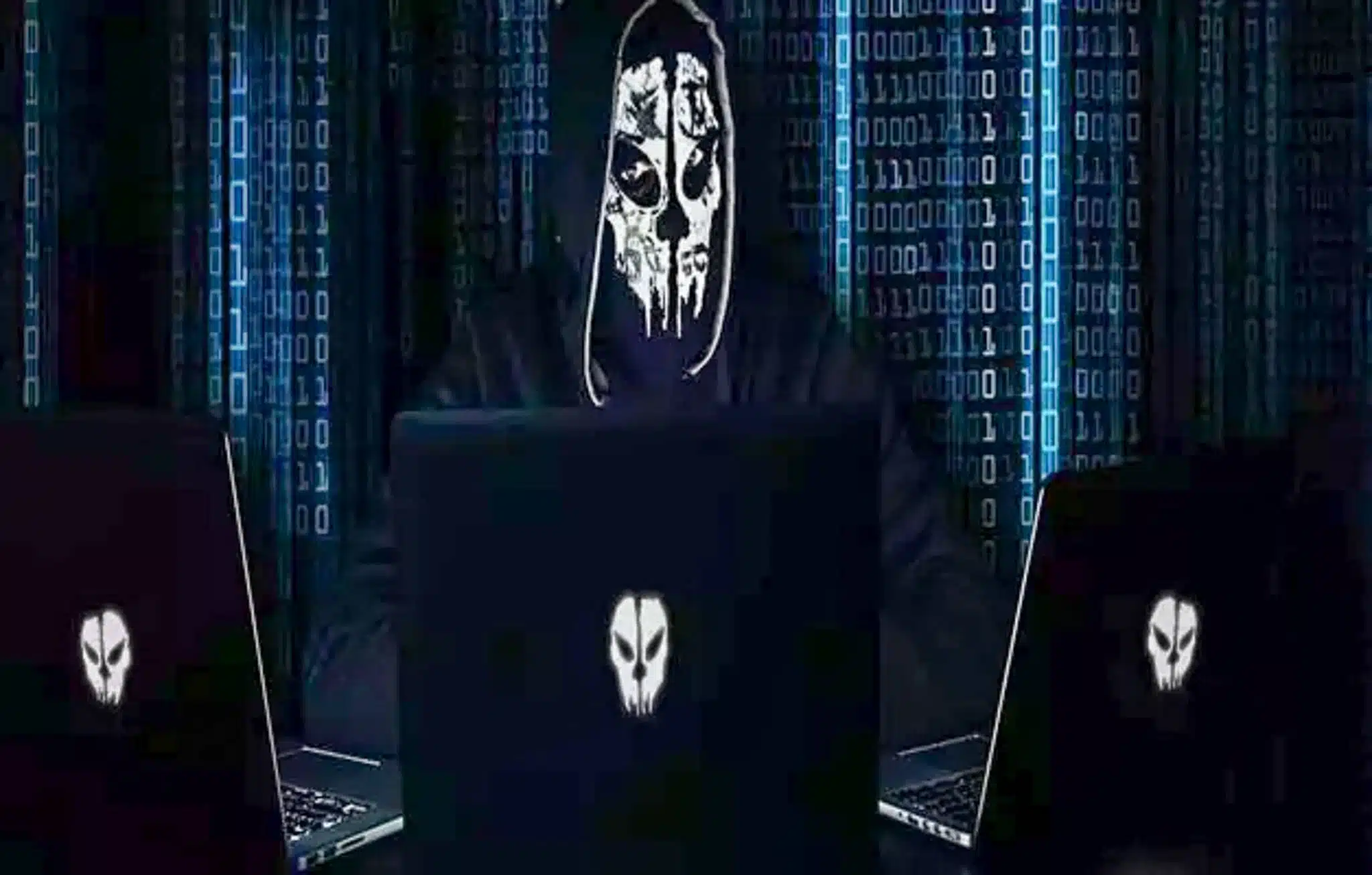 A skeleton in front of 3 computers