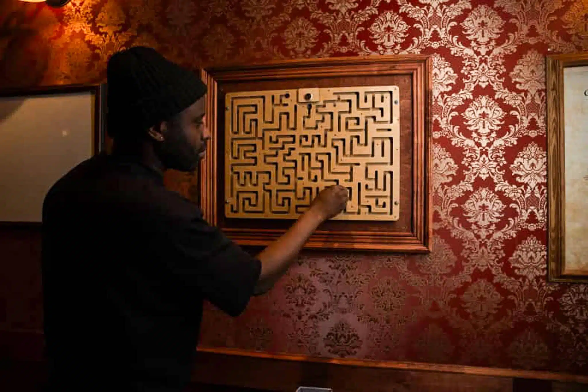 A man searching for a clue in a wall puzzle